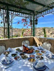 a table with plates of food on top at Dar Tazi - Medina View in Fez