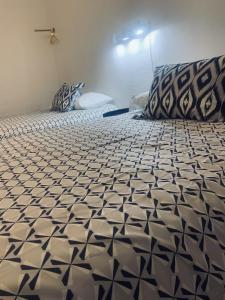 a bedroom with a bed with a black and white comforter at Dragonfly Motor Lodge in Panguitch