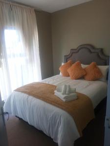 a bedroom with a bed with towels on it at Goshen Place in Cape Town