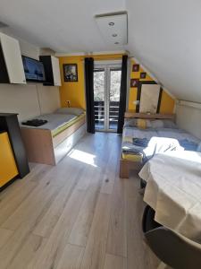 a dorm room with two beds and a window at Apartma LINA, Encijan D-38 in Bohinj