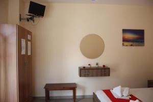 a bedroom with a bed and a mirror and a table at House Stamatis in Sarti