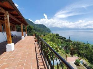 a balcony of a house with a view of the water at Casa Laguna: Best View In The World in Santa Cruz La Laguna