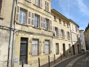 um edifício antigo numa rua da cidade com janelas em Typical 18th century flat, historical center em Avignon