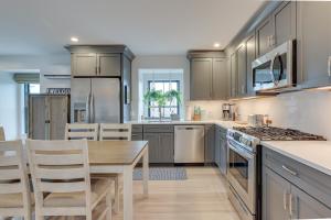 a kitchen with a wooden table and a dining room at Provincetown Vacation Rental Pet Friendly! in Provincetown