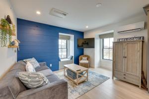 a living room with a couch and a blue wall at Provincetown Vacation Rental Pet Friendly! in Provincetown