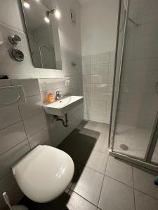 a bathroom with a toilet and a sink and a shower at Seepferdchen in Burgtiefe auf Fehmarn 