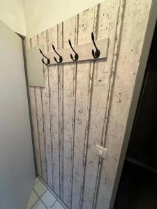 a bathroom with four pairs of scissors on a wall at Seepferdchen in Burgtiefe auf Fehmarn 