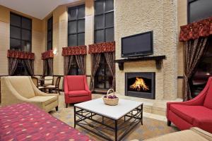 a living room with a fireplace and a tv at Holiday Inn Express Cincinnati West, an IHG Hotel in Dent