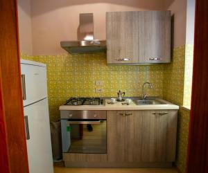 a kitchen with a sink and a stove at B&B A Modo Mio in Marsala