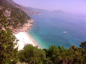 a view of a beach with a boat in the water at B&B Antico Telaio in Santa Maria Navarrese