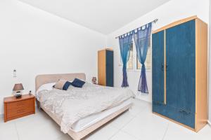 a bedroom with a bed and a blue cabinet at Apartments Stetonn in Kotor