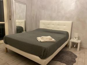 a bedroom with a bed with a towel on it at Manhattan House in Turin