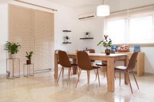 a dining room with a wooden table and chairs at Naelia in Pastida +28 photos