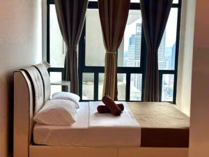 a bedroom with a bed with a large window at KLCC Kampung Baru Cottage - Homestay in Kuala Lumpur