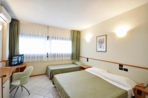 Postel nebo postele na pokoji v ubytování Hotel degli Ulivi