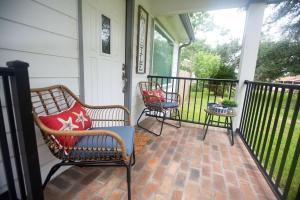 a porch with two chairs and a table at Captain's Cove in Long Beach