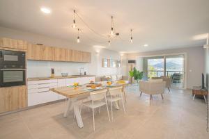 a kitchen and dining room with a table and chairs at Tangarane in Les Trois-Îlets