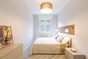 Habitación blanca con cama y ventana en NEW! Milano - Flowers Home, en Cusano Milanino