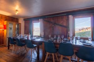 a dining room with a long table and chairs at Petit Mont Blanc Guest House in Peisey-Nancroix