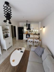 a living room with a couch and a table at Lily Beach - Apartment 408A in Sozopol