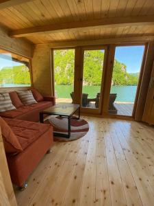 a living room with a couch and a table at Floating House Perućac in Perućac