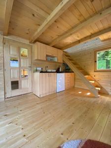 a large room with a staircase in a tiny house at Floating House Perućac in Perućac