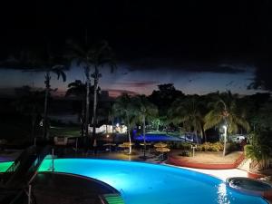 a view of a swimming pool at night at Appartement Madinina 6 personnes vue sur mer dans village vacances in Sainte-Luce