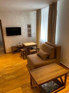 a living room with a couch and a table at Kolakovic in Brzeće