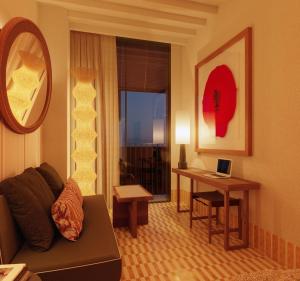 a living room with a couch and a table with a laptop at Hotel Casa Bassa in Valencia