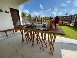 a wooden table with condiments on it on a patio at Carrapicho Patacho com Piscina Privativa in Pôrto de Pedras