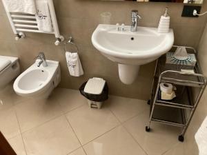 a bathroom with a sink and a toilet and a bidet at Domus B&B in Modugno