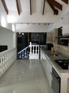 a kitchen with white cabinets and a counter top at Casa campestre in Melgar