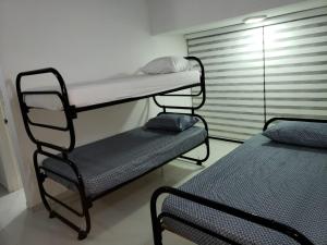 a bunk bed and a chair in a room at Casa campestre in Melgar