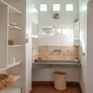 a bathroom with a sink and a mirror at La Kazaka Terre Sainte in Saint-Pierre