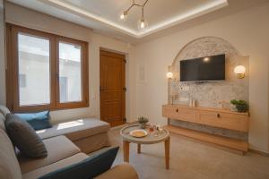 a living room with a couch and a tv at Jacuzzi maisonette in Sfakia center 'New 2023' in Khóra Sfakíon