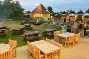 a group of tables and benches in a park at Elegance on Southview in Lincolnshire