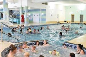 a group of people in a swimming pool at Elegance on Southview in Lincolnshire