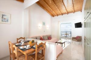 a kitchen and living room with a table and a couch at Nissaki Sea View Apartments in Nisakion