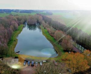 an aerial view of a lake with cars parked around it at pinocchio pirow in Pirow