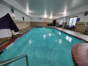 a large swimming pool with blue water at Holiday Inn Express- Waterloo/Cedar Falls, an IHG Hotel in Waterloo