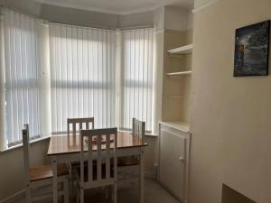 a dining room with a wooden table and chairs at 2 bed house near Sefton Park & Lark Lane in Liverpool