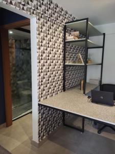 an office with a desk and a wall with a wall at Taguá life apartamento amplo moderno e encantador in Taguatinga