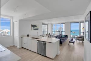 a kitchen and living room with views of the ocean at Condo 3 Bedrooms 2 min from the beach in Hallandale Beach