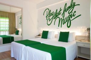 a bedroom with two beds with a sign on the wall at Lloret Vibe Affiliated by FERGUS in Lloret de Mar