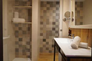a bathroom with a sink and a shower at Lloret Vibe Affiliated by FERGUS in Lloret de Mar