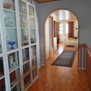 una sala de estar con un arco y una habitación con libros en Sentral og hyggelig bolig, en Svolvær