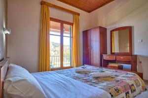 1 dormitorio con 1 cama con tocador y ventana en Theodora Apartments Agios Stefanos Corfu en Agios Stefanos