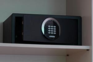 a tv on a shelf with a remote control at Lloret Vibe Affiliated by FERGUS in Lloret de Mar