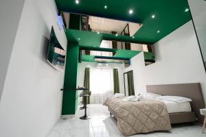 1 dormitorio con una escalera verde y 1 cama en Al Campanile H Napoli Centro, by ClaPa Group, en Nápoles
