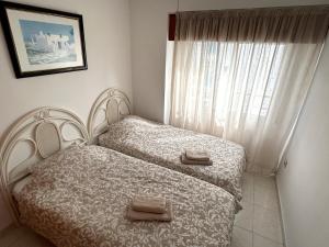 a bedroom with two twin beds and a window at Domo 5E Holiday apt with pool in Benidorm